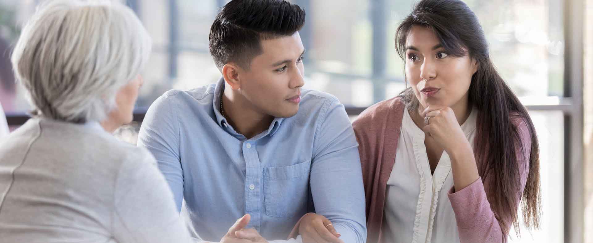 Young couple talking with clinical staff